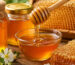 Natural honey being sampled from a food grade bulk container